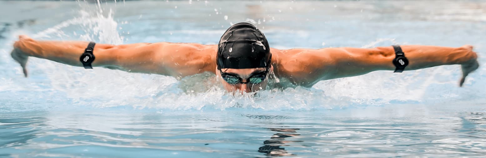 Butterfly swimmer with Morphwear sensors visible on forearms